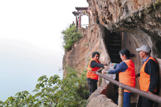 Cleaner pick up garbage on cliff everyday