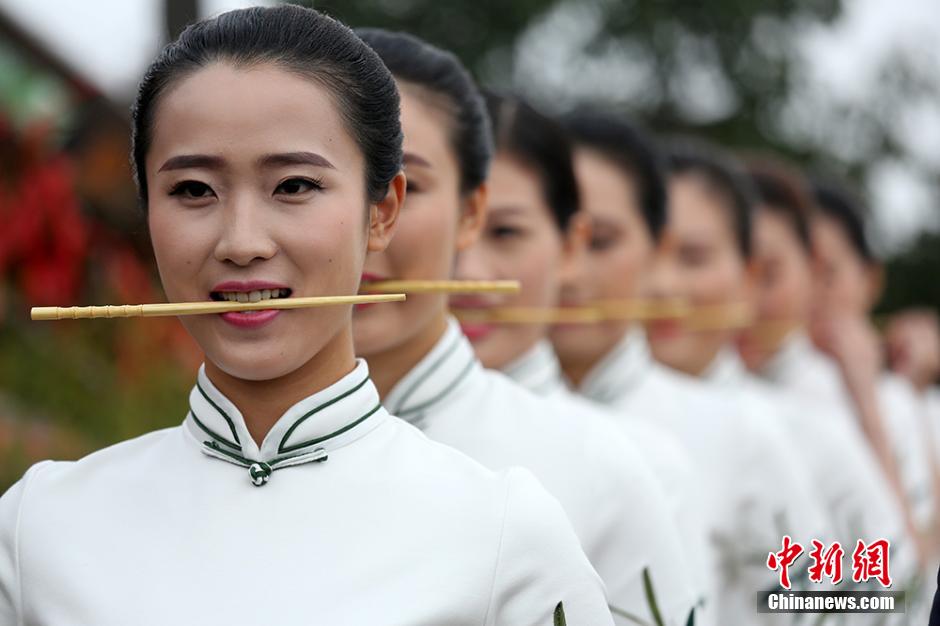 Girls practice smile with chopsticks