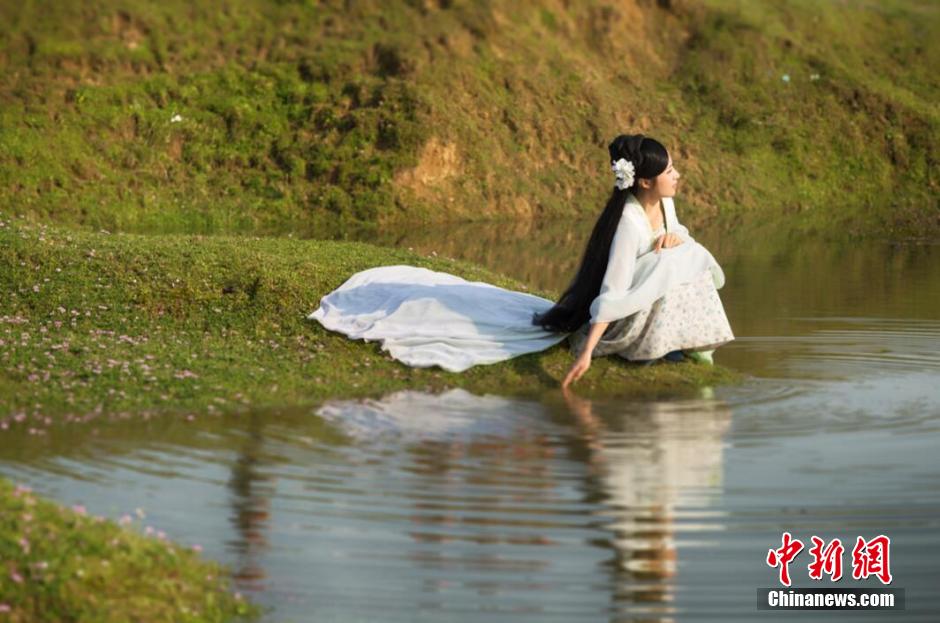 Female official wearing traditional Han costume to promote local tourism