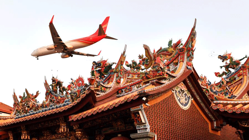 Ancient architecture attracts tourists to take photos with big airplanes