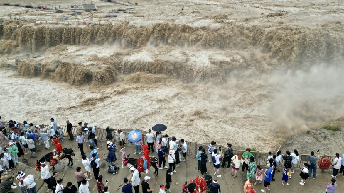 Yellow River Hukou waterfall roars beneath a rainbow