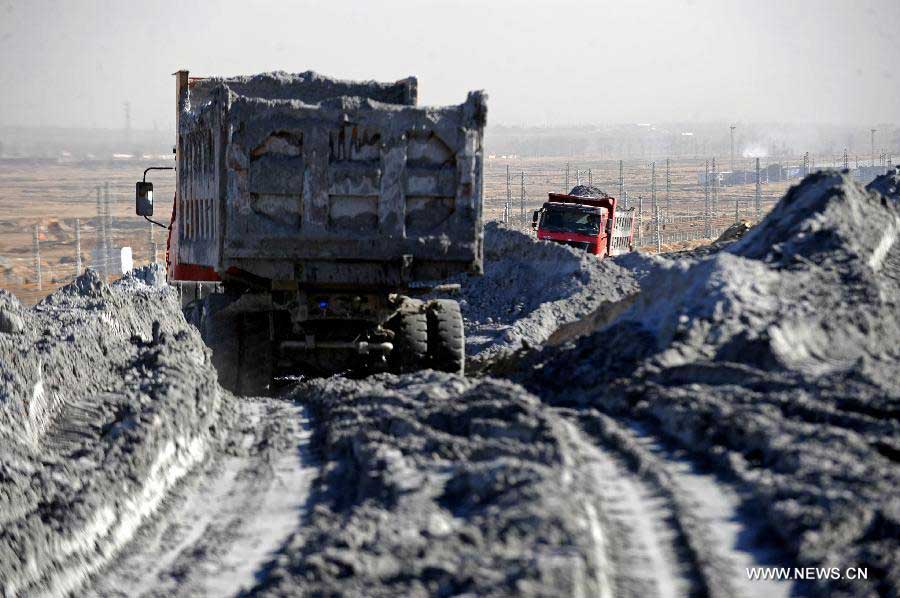 Trucks transport cinder in Shuozhou, north China's Shanxi Province, Oct. 31, 2012. As a city relying on coal power, Shuozhou has three major thermal power plants in its Shentou district. The thermal power plants emit some three million tons of coal ash each year. The pulverized fuel ash reclamation area, which used to be farmlands, is now covered with 120 million tons of coal ahses and becomes a huge pollution source. (Xinhua/Fan Minda) 