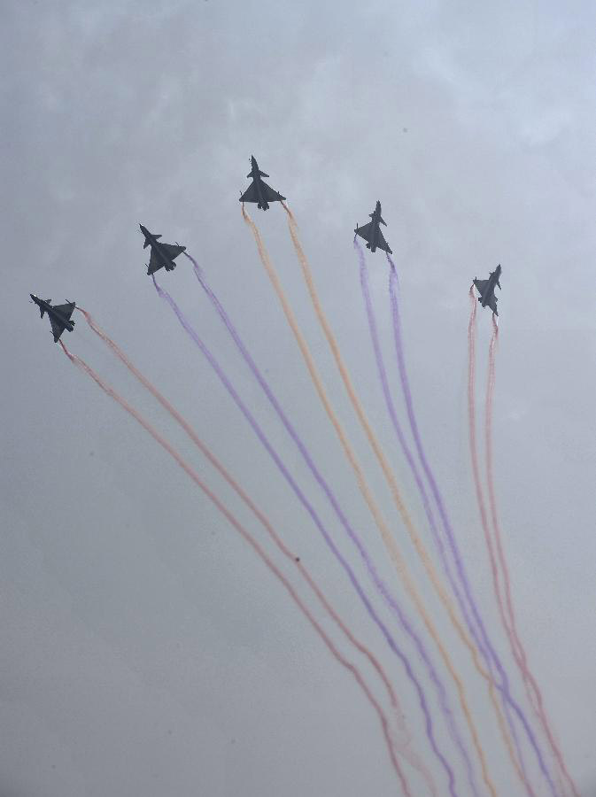 Flights from the China Air Force August 1st Aerobatic Team perform an air show during the opening ceremony of the 9th China International Aviation and Aerospace Exhibition in Zhuhai, south China's Guangdong Province, Nov. 13, 2012. About 650 exhibitors in the aviation and aerospace field took part in the six-day event. (Xinhua/Liang Xu) 