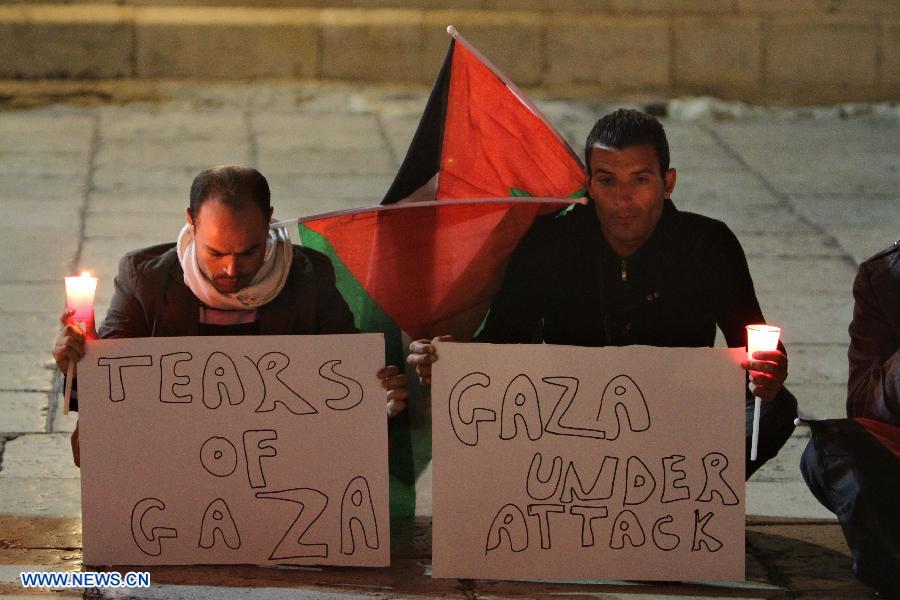 Activists hold candles during a solidarity protest near the Church of the Nativity in the West Bank city of Bethlehem on Nov. 14, 2012. Several Palestinians were killed following a series of Israel's concurrent airstrikes on Gaza city, among them was Ahmed al-Jaabari, top commander of Hamas armed wing Al-Qassam brigades, and more than 40 others wounded, government's emergency services in the Gaza Strip said. (Xinhua/Luay Sababa)