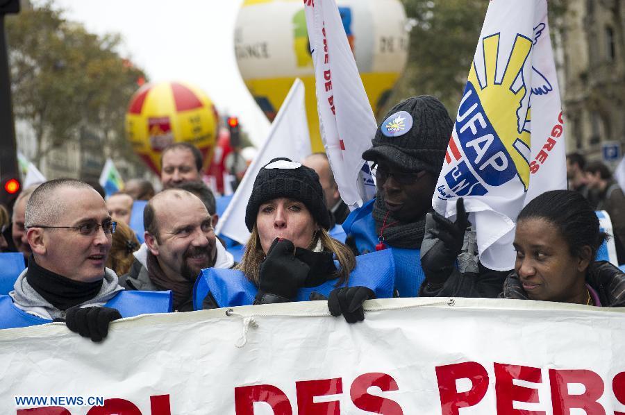 People attend a demonstration called by French trade unions, in Paris, France, Nov. 14, 2012. As part of the massive anti-austerity demonstration across Europe, thousands of French people took the streets on Wednesday to express their frustation over the austerity. (Xinhua/Etienne Laurent)