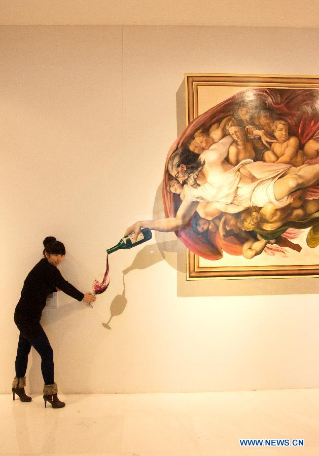 A visitor poses with a three dimensional painting during an exhibition in Tianjin, north China, Dec. 1, 2012. (Xinhua/Wang Qingyan)