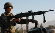 Afghan soldiers keep watch at attack site in Nangarhar