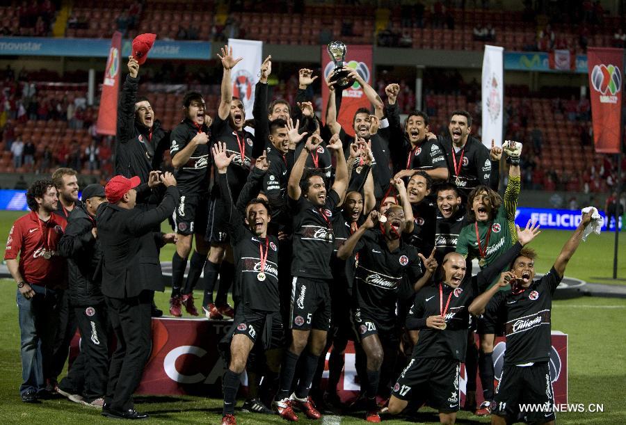 Players of Tijuana celebrate their victory over Toluca after their Mexican Apertura tournament final football match, at Nemesio Diez stadium, in Toluca, Mexico, on Dec. 2, 2012. (Xinhua/David de la Paz)