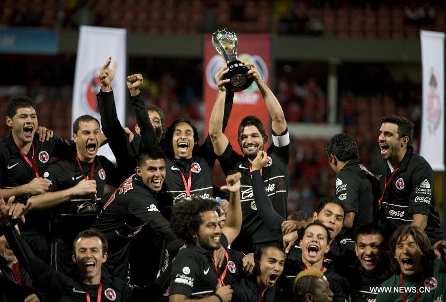 Players of Tijuana celebrate their victory over Toluca after their Mexican Apertura tournament final football match, at Nemesio Diez stadium, in Toluca, Mexico, on Dec. 2, 2012. (Xinhua/David de la Paz)