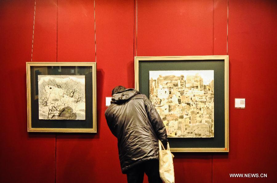 A man looks at a painting displayed during the preview of Beijing Council 2012 Autumn Auction held in Beijing International Hotel Convention Center in Beijing, capital of China, Dec. 3, 2012. The preview, which kicked off on Sunday, showcased over 2500 artworks of different varieties such as paintings, chinaware and sculptures. The auction will last from Dec. 5 to Dec. 7. (Xinhua/Zhang Cheng)