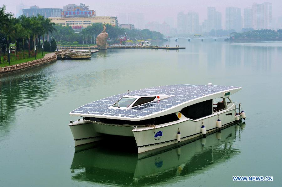 Photo taken on Dec. 5, 2012 shows a solar yacht on the Yundang Lake in Xiamen, southeast China's Fujian Province. The 15-meter-long and 6-meter-wide solar yacht was put into use on Wednesday. The yacht can transform the collected solar energy into electricity to provide power supply for the facilities on board. (Xinhua/Zhang Guojun) 