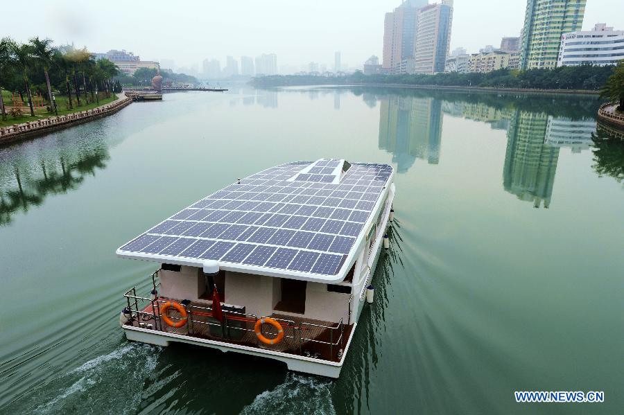 Photo taken on Dec. 5, 2012 shows a solar yacht on the Yundang Lake in Xiamen, southeast China's Fujian Province. The 15-meter-long and 6-meter-wide solar yacht was put into use on Wednesday. The yacht can transform the collected solar energy into electricity to provide power supply for the facilities on board. (Xinhua/Zhang Guojun) 