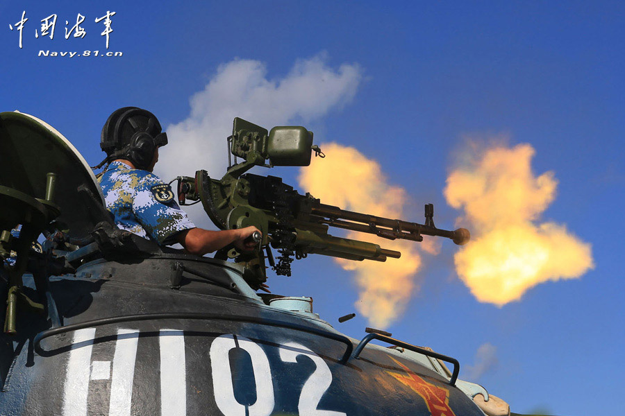 A tank company under a maritime garrison command of the Chinese People's Liberation Army (PLA) stationed on the Sansha Island conducts a live-ammunition shooting training with tank-mounted anti-aircraft machine gun, in a bid to temper troops' combat capability. (navy.81.cn/Chen Xianling, Liu Weiping)