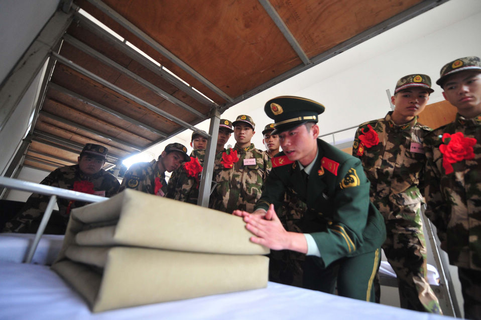 New recruits for the People's Liberation Army wait for the train to leave at a train station. The People's Liberation Army has launched its annual winter conscription this year. (Xinhua)