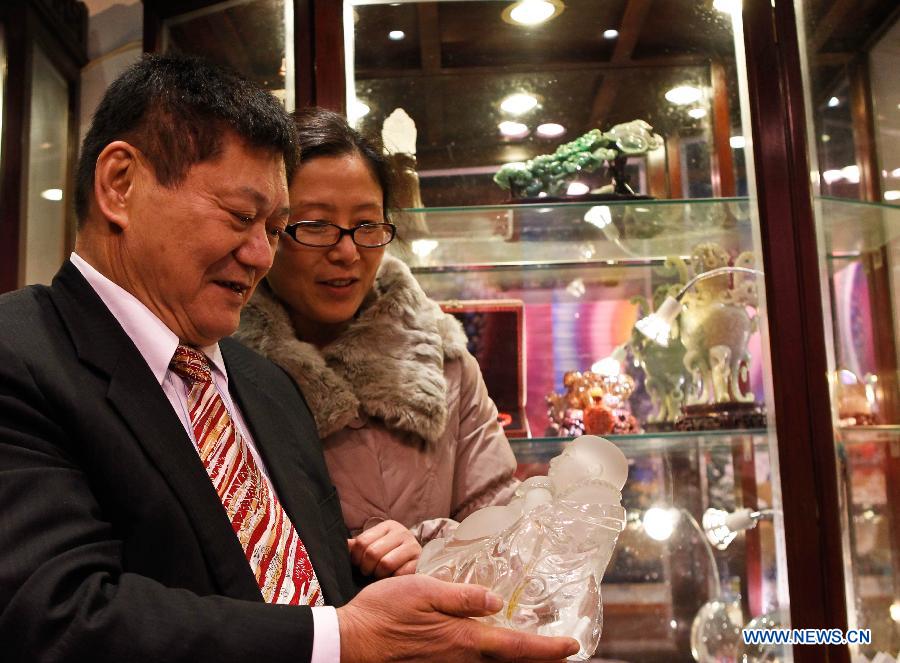 Taiwanese sculptor Hung Fu-shou (L) and his wife Gao Mei examine a piece of work in Taizhou, east China's Jiangsu Province, Dec. 8, 2012. Hung Fu-shou and Gao Mei, who came from Nanjing City of Jiangsu Province, first met each other 18 years ago and got married two years later. (Xinhua/Xue Dongmei)