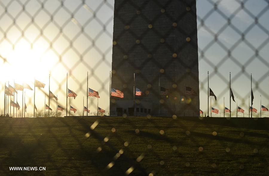 U.S. flags fly at half staff at the base of the Washington Monument to honor the victims of the Connecticut shooting incident in Washington D.C., capital of the United States, Dec. 14, 2012. U.S. President Barack Obama on Friday ordered U.S. flags to be flown at half-staff at the White House and all public buildings and grounds, as a mark of respect for the victims of a deadly shooting spree at Sandy Hook Elementary School in Newtown, Connecticut, which took place earlier in the day. (Xinhua/Wang Yiou) 