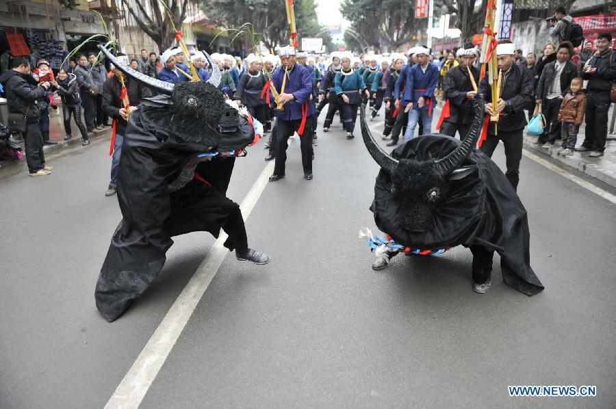 People of the Dong ethnic group dressed as bulls perform during the Sama Festival on a street in Rongjiang County, southwest China's Guizhou Province, Dec. 18, 2012. The Sama Festival, an ancient traditional festival commemorating the woman ancestors of the Dong ethnic group, was listed as one of China's state intangible cultural heritages in 2006. (Xinhua/Ou Dongqu) 