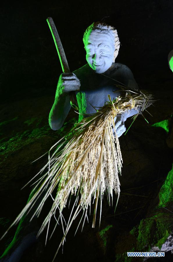 Photo shows the sculptures imitating ancient people's life at the Xianren Cave in Dayuan Township of Wannian County, east China's Jiangxi Province. Xianren Cave is the location for historically important finds of prehistoric pottery sherds and rice remains. (Xinhua/Zhou Ke)