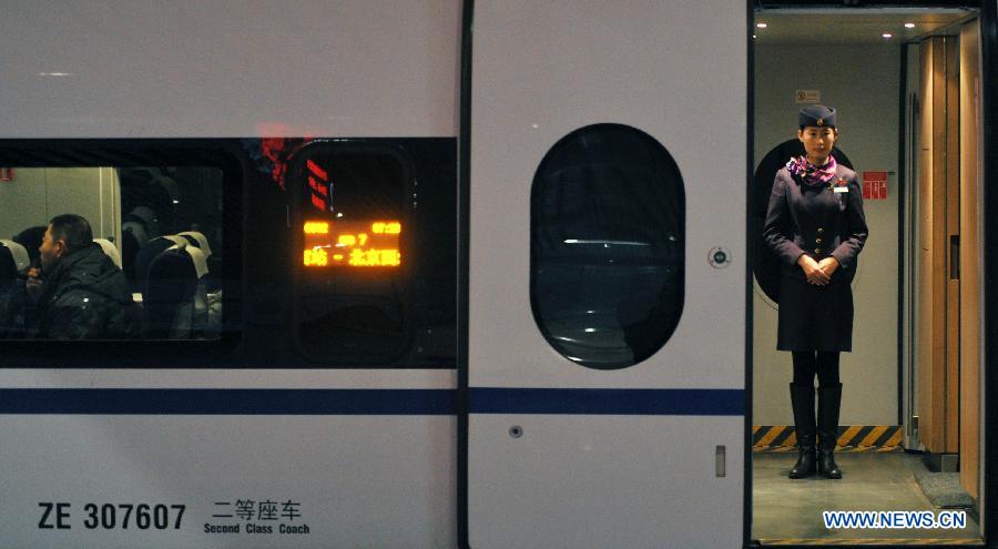 A stewardess wait to serve passengers in high-speed train G502 at the Changsha South Railway Station in Changsha, capital of central China's Hunan Province, Dec. 26, 2012. The Changsha South Railway Station is one of the stops of the 2,298-kilometer Beijing-Guangzhou High-speed Railway, the world's longest, which was put into operation on Wednesday.  (Xinhu/Li Ga) 