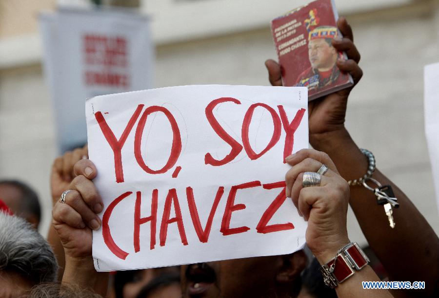 A supporter of Venezuelan President Hugo Chavez participates in a demonstration outside the National Assembly, in Caracas, Venezuela, on Jan. 5, 2013. Venezuelan Vice President Nicolas Maduro said Friday that ailing President Hugo Chavez could be sworn in by the Supreme Court at a later date if he is not able to take the oath of office as scheduled on Jan. 10. (Xinhua/Juan Carlos Hernandez) 