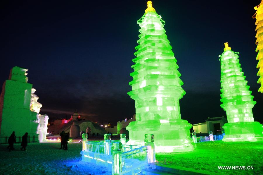 Visitors view the ice sculptures during the 16th Shenyang International Ice and Snow Festival in Shenyang, capital of northeast China's Liaoning Province, Jan. 10, 2013. The festival will last for three months. (Xinhua/Huang Jinkun)