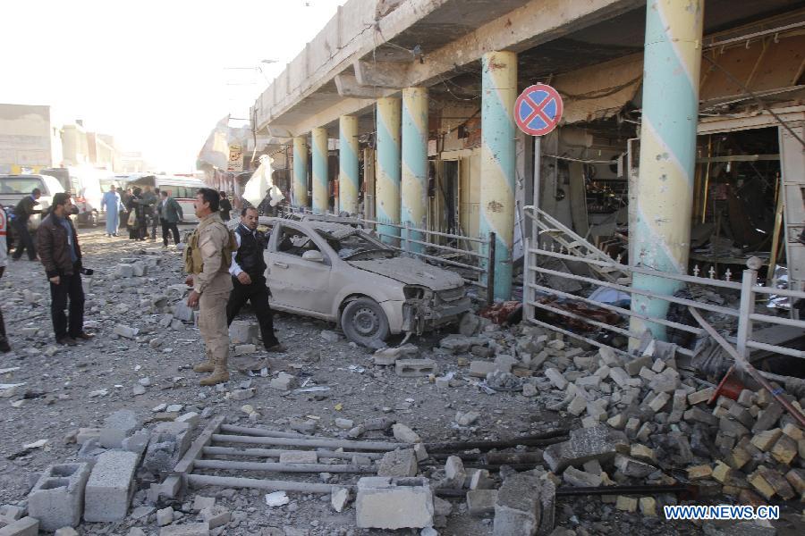 Photo taken on Jan. 16, 2013 shows the site of bomb attack in Kirkuk, Iraq. Up to 17 people were killed and 133 wounded in two bomb attacks targeting offices of Kurdish parties in the ethnically mixed cities of Kirkuk and Tuz-Khurmato in northern Iraq on Wednesday, according to the police. (Xinhua/Dina Assad)