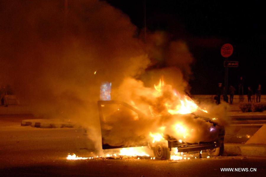 A burning vehicle is seen during clashes in the coastal city of Alexandria, Egypt, on Jan. 20, 2013. Police and protesters clashed here on Sunday after the presiding judge investigating the killing of protesters in Egypt's 2011 uprising returned the case. (Xinhua/STR)