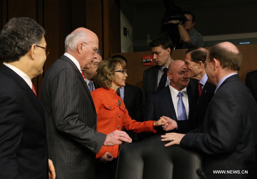 Former U.S. Rep. Gabby Giffords (C) who is a shooting victim arrives at the hearing for a Senate Judiciary Committee about gun control on Capitol Hill in Washington D.C., the United States, Jan. 30, 2013. (Xinhua/Fang Zhe) 