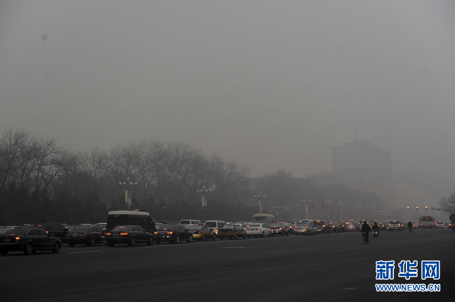 Rain and light snow falls in Beijing slightly disperse the lingering smog that suffocated the city for a few days. A fresh cold front hit the central and eastern China on Thursday and was expected to ease the smog that suffocated these areas in the past few days. Because of the freezing temperature, the rainwater turned to thin ice on the road, leading to many slips and traffic accidents in Beijing on Thursday. (Photo/Xinhua)