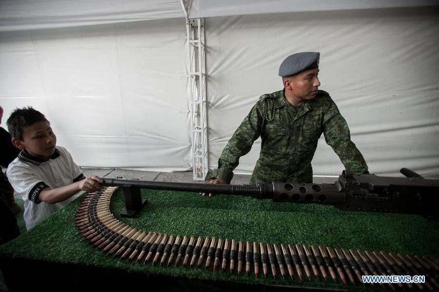 A boy participates in an activity during the Mexican Army's Exhibition "Armed Forces, Passion to Serve Mexico" held in the Zocalo of Mexico City, capital of Mexico, on Feb. 15, 2013. (Xinhua/Pedro Mera)