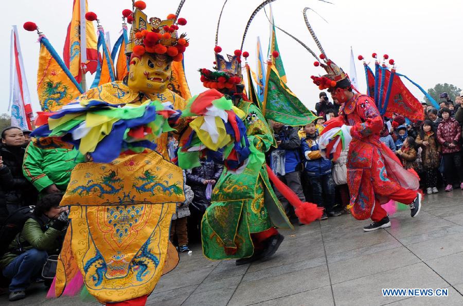 Performers perform Nuo dance, a kind of exorcising dance, during the 14th Folk Culture Festival in Liyang City, east China's Jiangsu Province, Feb. 17, 2013. (Xinhua/Han Yuqing)