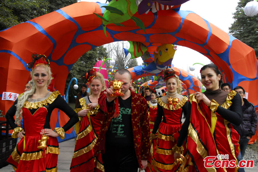 People in colorful costumes participate in a parade held to celebrate the Jinsha Sun Festival in Jinsha Village, Chengdu, Southwest China's Sichuan Province, February 20, 2013. Jinsha Village is home to the Jinsha Relics Museum, which, located at the Jinsha Archeological Site, is a theme park-style museum for the protection of, research into and display of Jinsha relics and archaeological finds. (CNS/Jin Sha)