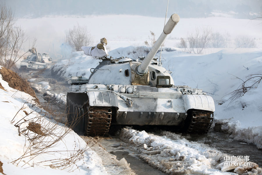 The tank echelon of an armored brigade under the Shenyang Military Area Command (MAC) of the Chinese People's Liberation Army (PLA) recently completed training on eight subjects, including command and control, concealing and camouflage, anti-interference and rush repair on battlefield etc., and conducted all-dimensional test of equipment's technical performance, personnel's equipment operation capability and tactical coordination and command under frigid weather conditions, greatly enhancing the combat and command capabilities of the troop unit under severely cold conditions. (mil.cnr.cn)