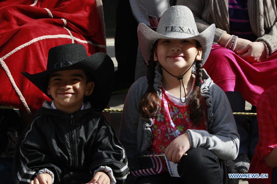 Children dressed up as cowboys attend the annual Houston Rodeo parade in Houston, the United States, Feb. 23, 2013. (Xinhua/Song Qiong) 