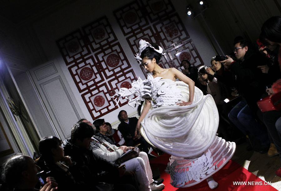 A model displays a creation by Chinese designer Xu Ming at Chinese Cultural Center in Paris, France, Feb. 25, 2013. (Xinhua/Gao Jing)