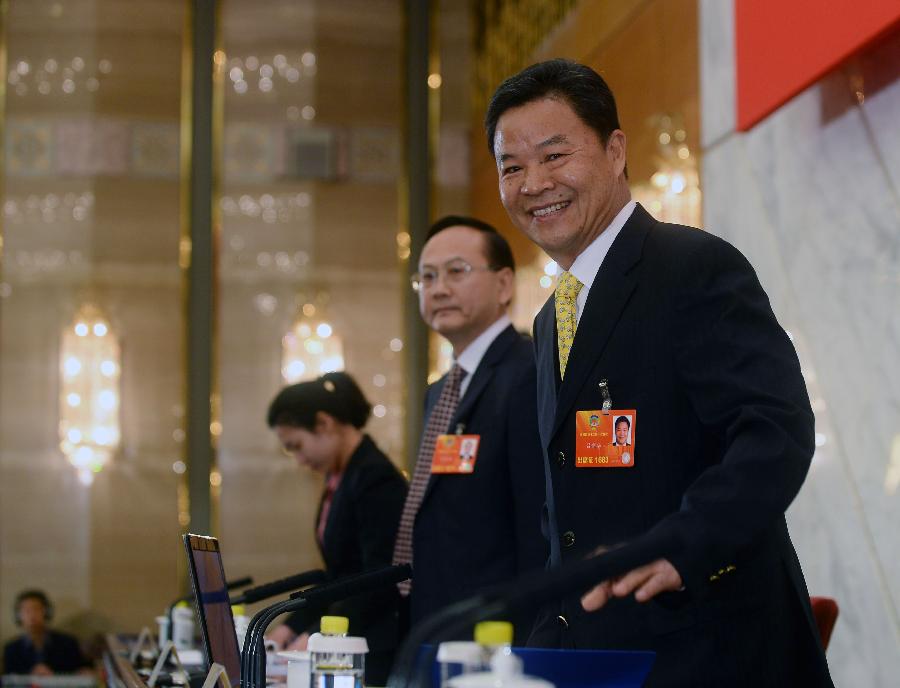 Lu Xinhua (front), spokesman of the first session of the 12th Chinese People's Political Consultative Conference (CPPCC) National Committee, reacts at a news conference on the CPPCC session in Beijing, capital of China, March 2, 2013. The first session of the 12th CPPCC National Committee is scheduled to open in Beijing on March 3. (Xinhua/Jin Liangkuai) 