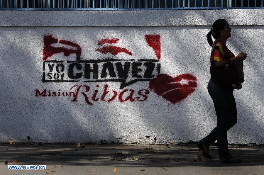 A resident walks past a wall with a painting of Venezuelan President Hugo Chavez on a street in Caracas, capital of Venezuela, on Mar. 2, 2013. Venezuela's ailing President Hugo Chavez is undergoing chemotherapy in the capital's military hospital, Vice President Nicolas Maduro said Friday, calling for respect for Chavez and his family. (Xinhua/Mauricio Valenzuela)