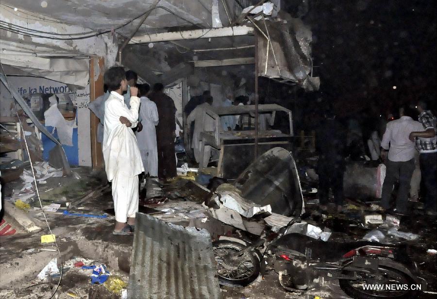 People gather at the blast site in Karachi on March 3, 2013. At least 40 people including women and kids were killed and over 135 people were injured when twin blasts hit Pakistan's southern port city of Karachi on Sunday night, local media and police said. (Xinhua/Masroor)  