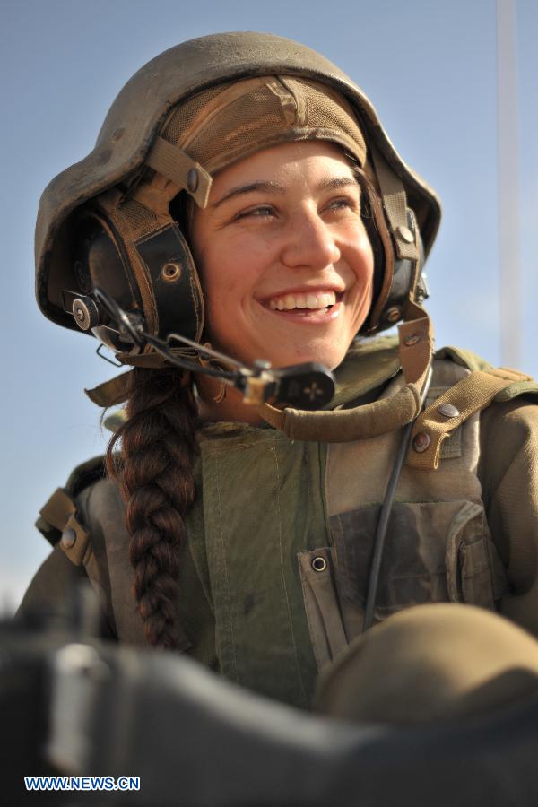 A female soldier of Israel Defense Forces (IDF)'s Shiryon (tank corps) unit takes part in a shooting training at Shizafon Armor Corps Training Base, south Israel, March 7, 2013 . These female soldiers will become instructors in Shiryon unit after finishing their 4-month training. (Xinhua/ Yin Dongxun) 