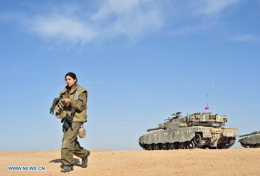 A female soldier of Israel Defense Forces (IDF)'s Shiryon (tank corps) unit takes part in a shooting training at Shizafon Armor Corps Training Base, south Israel, March 7, 2013 . These female soldiers will become instructors in Shiryon unit after finishing their 4-month training. (Xinhua/ Yin Dongxun) 