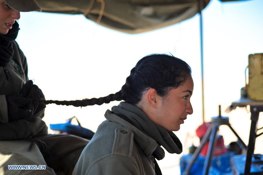 Female soldiers of Israel Defense Forces (IDF)'s Shiryon (tank corps) unit take part in a shooting training at Shizafon Armor Corps Training Base, south Israel, March 7, 2013 . These female soldiers will become instructors in Shiryon unit after finishing their 4-month training. (Xinhua/ Yin Dongxun) 