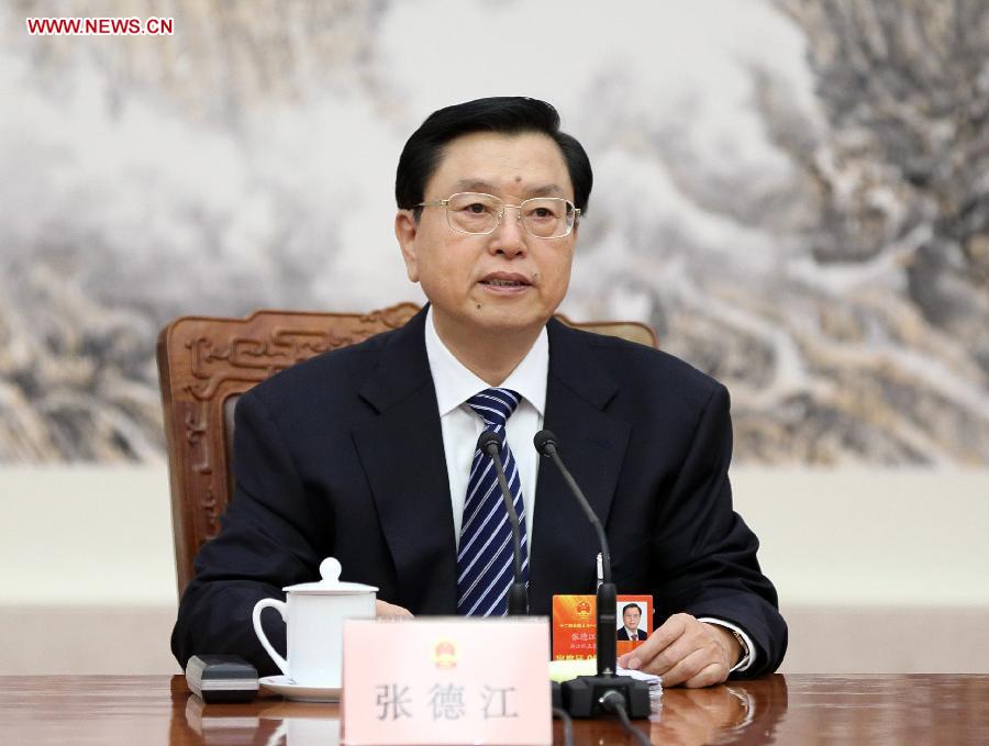 Zhang Dejiang, executive chairperson of the presidium of the first session of the 12th National People's Congress (NPC), presides over the third meeting of the presidium's executive chairpersons at the Great Hall of the People in Beijing, capital of China, March 12, 2013. (Xinhua/Lan Hongguang)