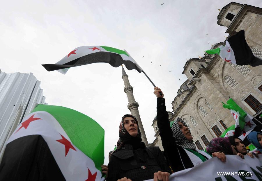 Protesters hold flags during a demonstration in Istanbul, Turkey, on March 15, 2013. More than 1,000 Turks and Syrians held a rally in Turkey's Istanbul city in protest of the Syrian government on Friday, two years after the unrest broke out in Syria. (Xinhua/Ma Yan) 