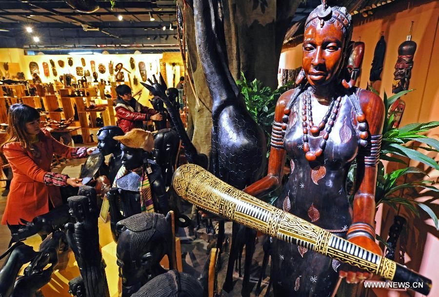 Merchants arrange African wood carvings at the International Trade City in Yiwu, a city famous for small commodities trade in east China's Zhejiang province, Dec. 17, 2011. China-Africa economic and trade cooperation is mutually beneficial, strongly boosting the common development of the two sides. Chinese President Xi Jinping will visit Tanzania, South Africa and the Republic of Congo later this month and attend the fifth BRICS summit on March 26-27 in Durban, South Africa. (Xinhua/Tan Jin) 