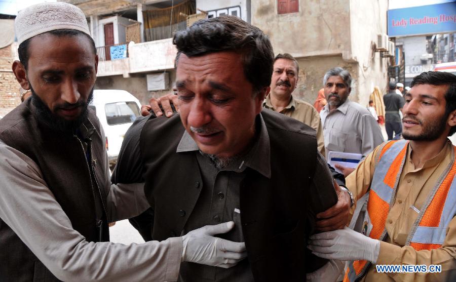 A man mourns over the death of his relative at a hospital in northwest Pakistan's Peshawar on March 21, 2013. At least 12 people were killed and 35 others injured when a bomb hit a refugee camp in Pakistan's northwest city of Nowshera on Thursday morning, local district officials said. (Xinhua/Ahmad Sidique)