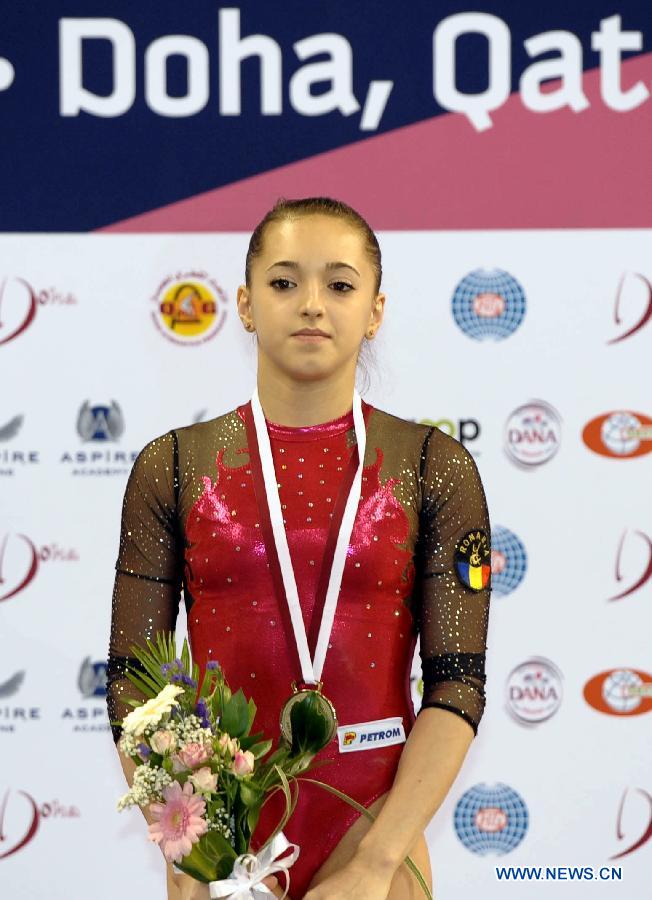 Larisa Andreea Iordache of Romania reacts during the awarding ceremony for women's vault at the 6th FIG Artistic Gymnastics world Challenge Cup in Doha, Qatar, March 28, 2013. Larisa Andreea Iordache took the silver medal with 14.675 points. (Xinhua/Chen Shaojin)