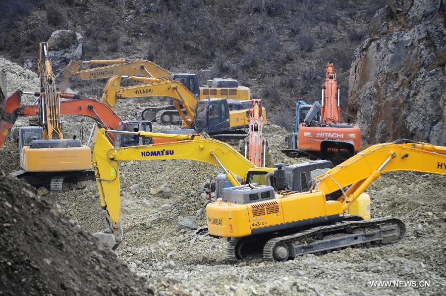 Rescuers and machines work at the accident site in Maizhokunggar County of Lhasa, southwest China's Tibet Autonomous Region, March 31, 2013. Thirteen bodies have been found until 6:30 p.m. Sunday at the site of a mining area landslide. The disaster struck a workers' camp of the Jiama Copper Polymetallic Mine at about 6 a.m. on Friday, burying 83 workers. (Xinhua/Liu Kun)