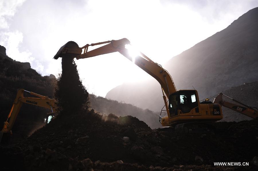 An excavator works at the accident site in Maizhokunggar County of Lhasa, southwest China's Tibet Autonomous Region, March 31, 2013. Thirteen bodies have been found until 6:30 p.m. Sunday at the site of a mining area landslide. The disaster struck a workers' camp of the Jiama Copper Polymetallic Mine at about 6 a.m. on Friday, burying 83 workers. (Xinhua/Liu Kun)