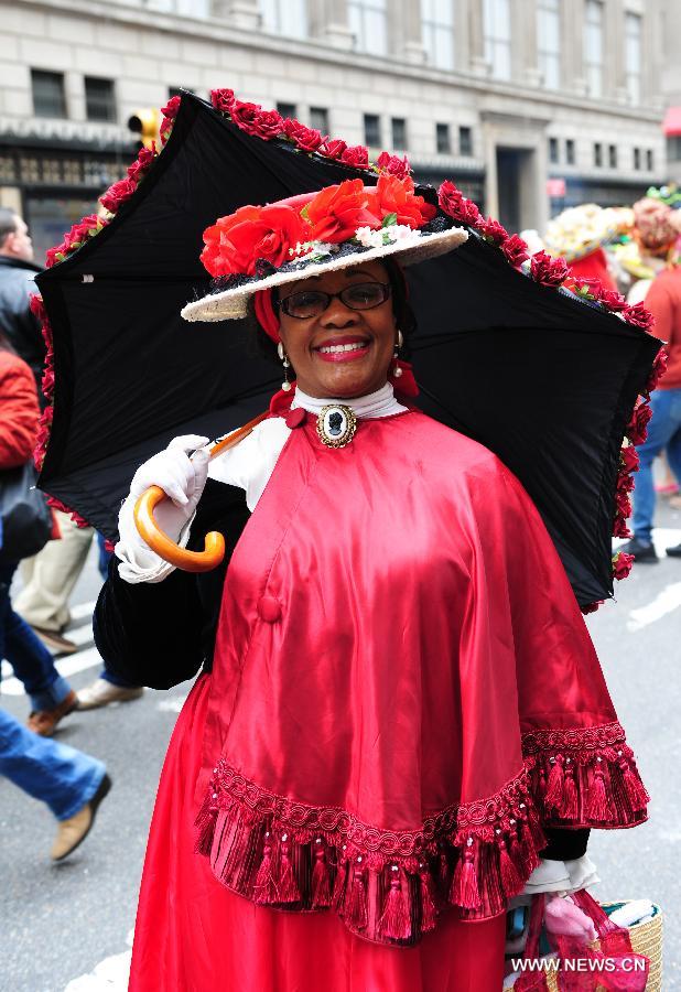 A woman poses for photos in the annual Easter Bonnet Parade in Manhattan of New York, the United States, March 31, 2013. With a history of more than 100 years, the New York Easter Bonnet Parade is held annually on the 5th Avenue near the Saint Patrick's Cathedral. Adults, children and even pets in creative colorful bonnets and outfits participate in the event, which also attract thousands of New York residents and tourists. (Xinhua/Deng Jian) 