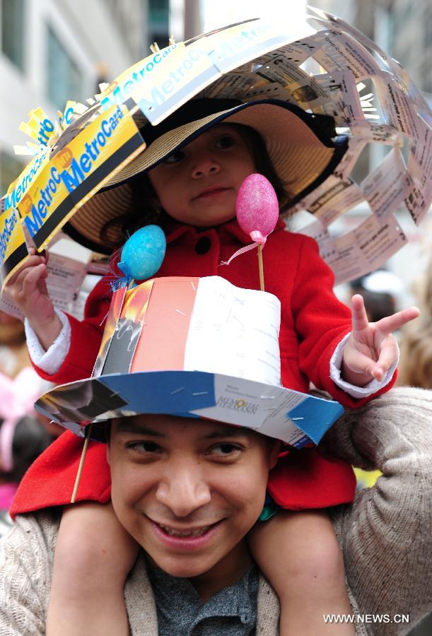 A girl wearing a bonnet made up of MetroCards takes part in the annual Easter Bonnet Parade in Manhattan of New York, the United States, March 31, 2013. With a history of more than 100 years, the New York Easter Bonnet Parade is held annually on the 5th Avenue near the Saint Patrick's Cathedral. Adults, children and even pets in creative colorful bonnets and outfits participate in the event, which also attract thousands of New York residents and tourists. (Xinhua/Deng Jian) 